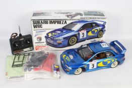 A R/C petrol 1:10 scale 4 WD Subaru Impreza WRC with controller and original box with decals and