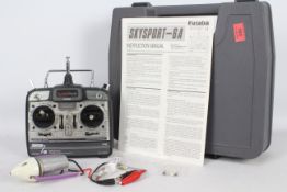 A Futuba Skysport 6A radio control transmitter with an electric aircraft motor and various crystals