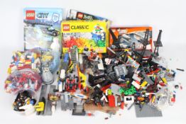 Lego - A large tub of loose Lego pieces and some part built models,