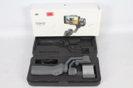 A OSMO mobile 2 mobile phone camera gimbal in original box. (This does not constitute a guarantee.