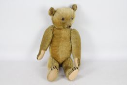 A golden mohair jointed teddy bear with growler.