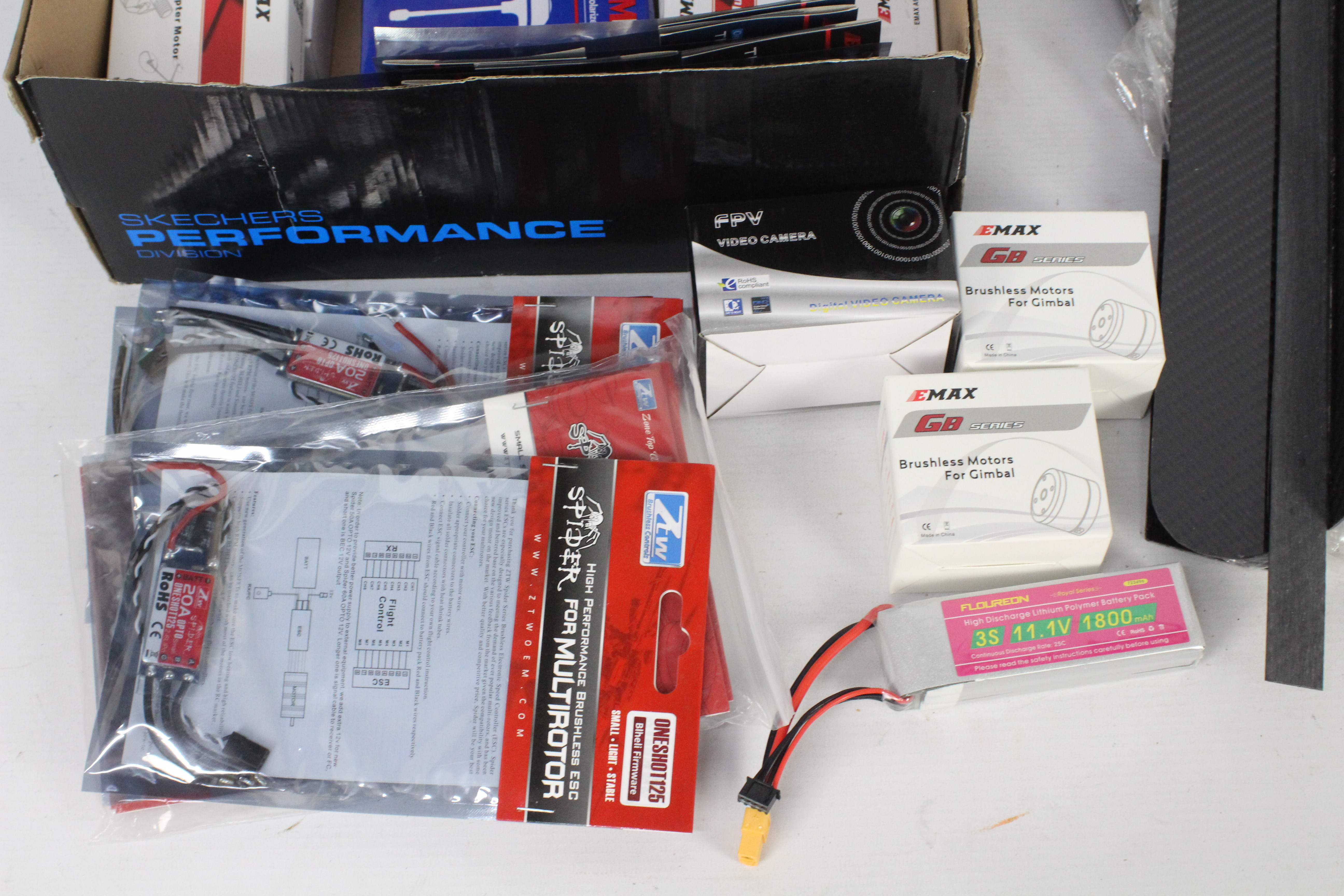 A collection of R/C spare parts and a carbon fibre quad copter frame with a box of brushless motors. - Image 2 of 5