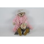 Ann Inman Looms - A mohair bear by Ann Inman with glass eyes and wired limbs.