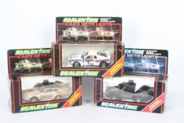 Scalextric - Three boxed Scalextric slot cars with lights.