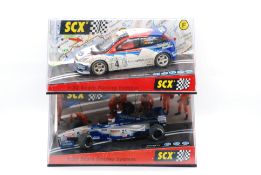 SCX - Two boxed SCX 1:32 slot cars.