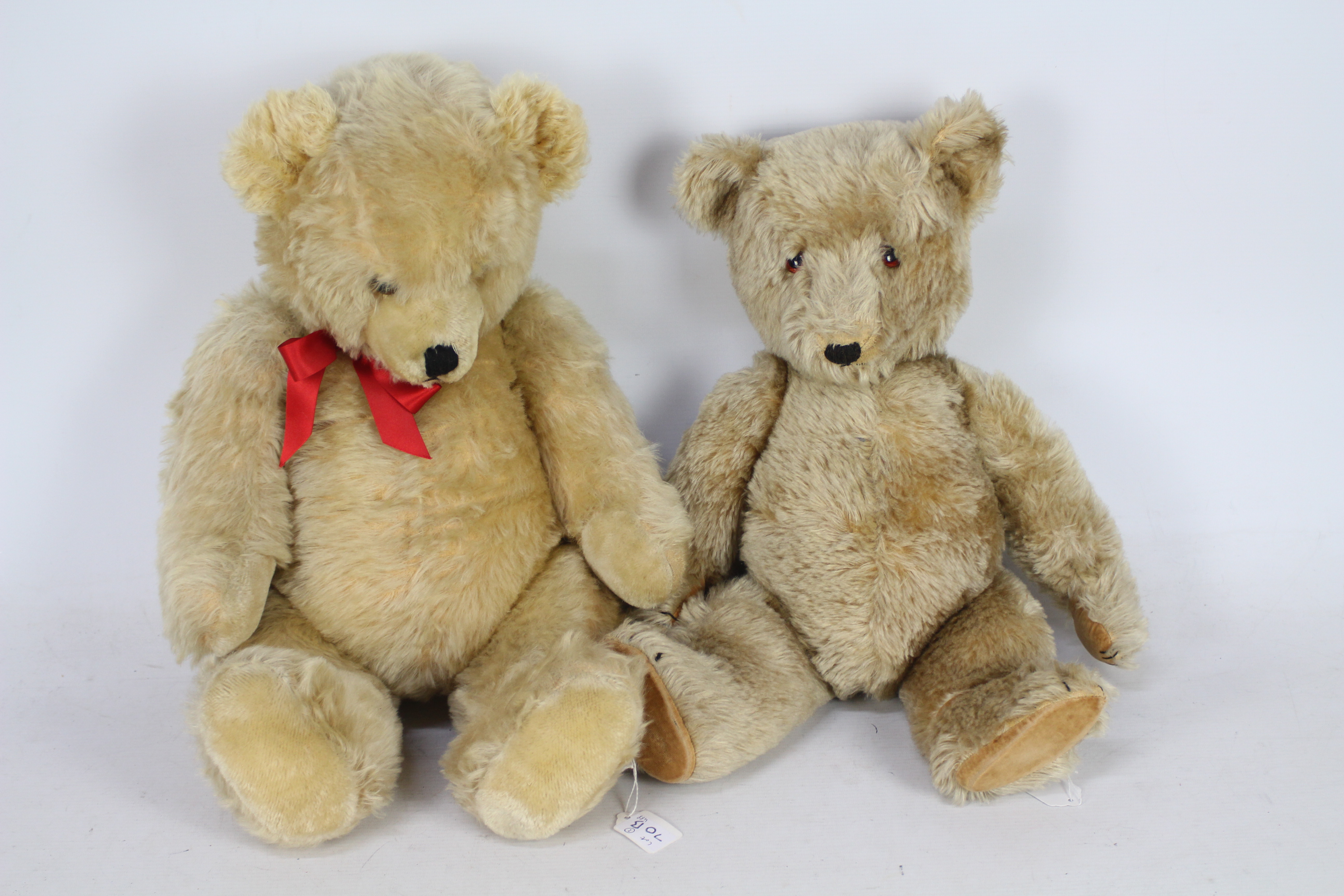 Two mohair teddy bears with glass eyes, metal joints, and stitched nose.