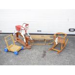 A collection of 2 wooden rocking horses, a sled and a trolley. All wooden and playworn as pictured.