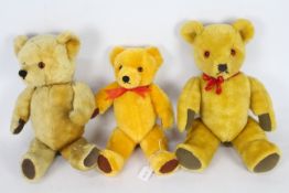 Three mohair teddy bears with glass eyes, suede paws, and stitched noses.