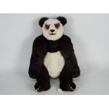 A mohair panda with glass eyes. Panda also has poly eyelids, nose, mouth, paws, and nails.