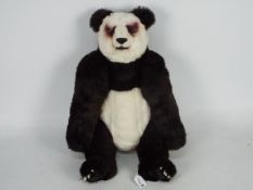 A mohair panda with glass eyes. Panda also has poly eyelids, nose, mouth, paws, and nails.