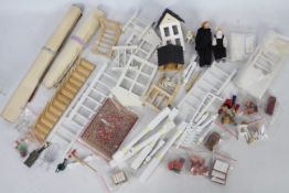 Wooden dolls house furniture including stairs, wallpaper, pots and pans, napkins and two dolls.