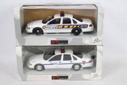 UT Models - Two boxed 1:18 scale UT Models UT0597 Chevrolet Caprice US police cars in Watkins Glen