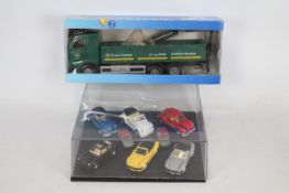 A collection of 8 Ertl classic and sports cars plus Emek #50458 Volvo FH Dropside with crane.