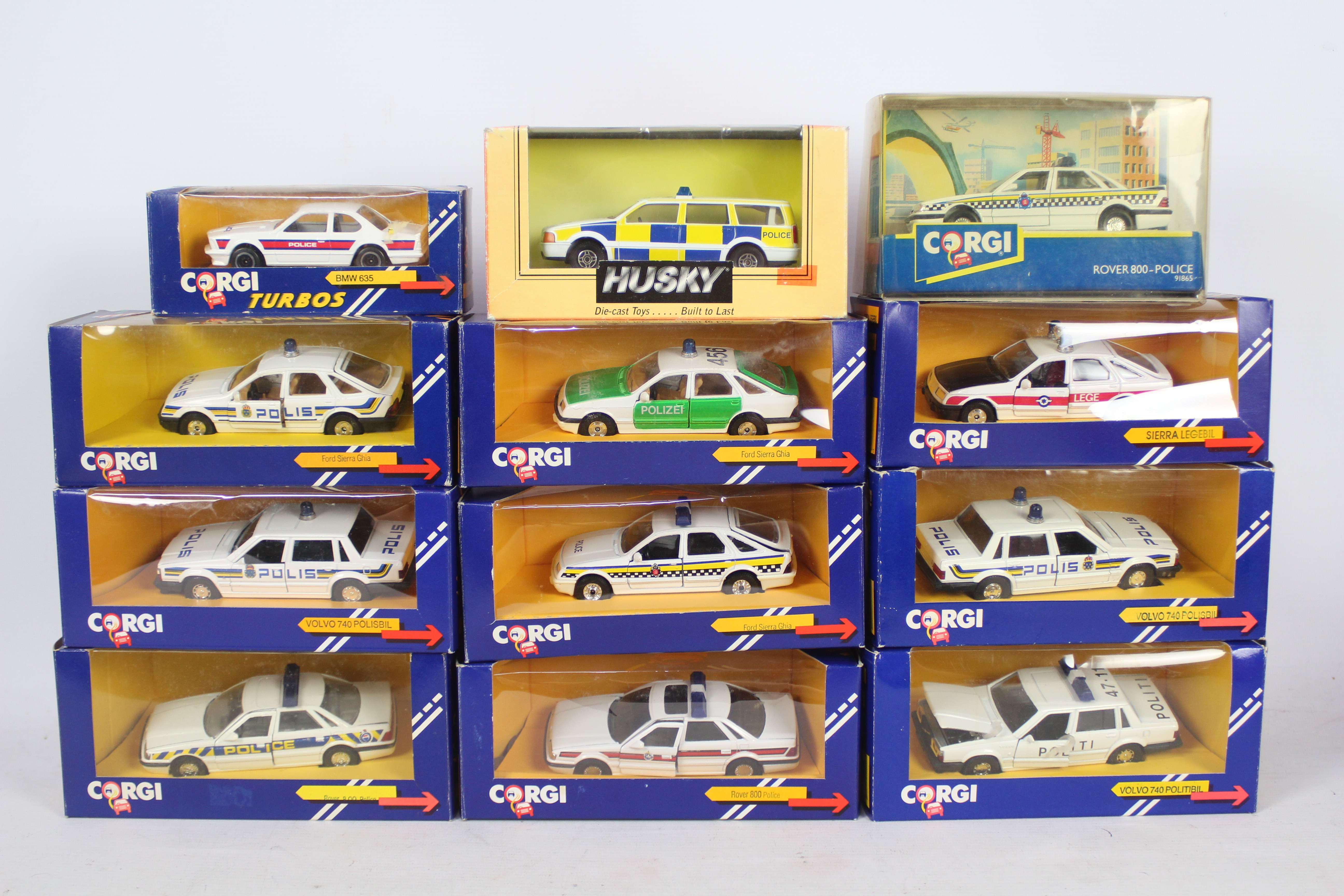 Corgi, Husky - A squad of 12 boxed diecast 'Police' cars predominately 1:43 scale by Corgi.