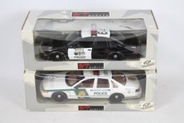 UT Models - Two boxed 1:18 scale UT Models UT0597 Chevrolet Caprice US police cars in Brea Police