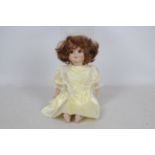 Armand Marseille - A reproduction Armand Marseille googly bisque headed doll. The doll approx.