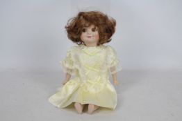 Armand Marseille - A reproduction Armand Marseille googly bisque headed doll. The doll approx.