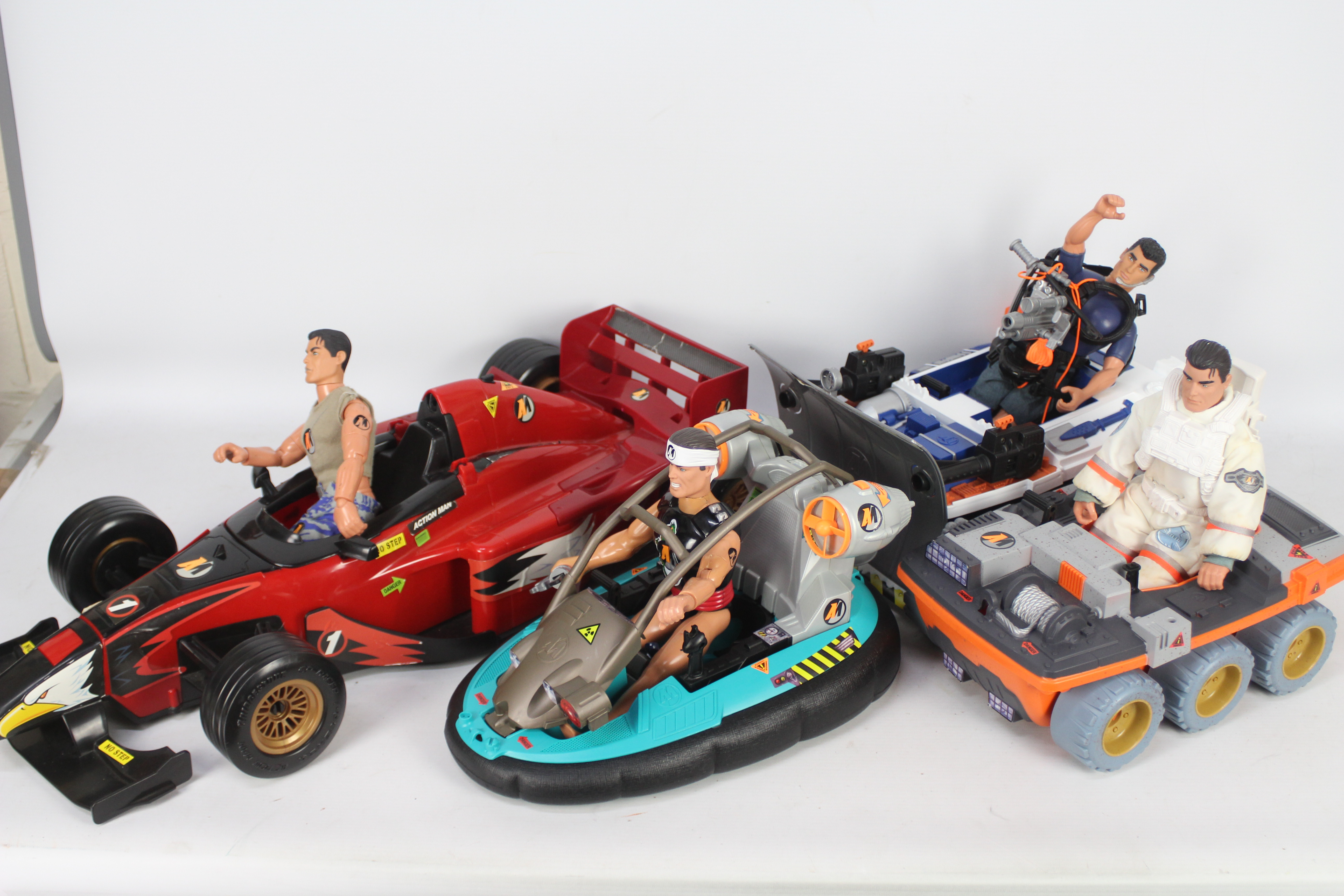 Action Man. A collection of 4 figures and 4 vehicles.