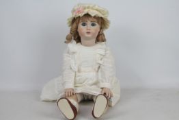 Jules Nicholas Steiner - A reproduction bisque headed doll of a 'Jules Nicholas Steiner' doll.