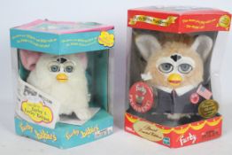 A collection of two Furby babies toys to include model 70-940 in white and #70665 In damaged box