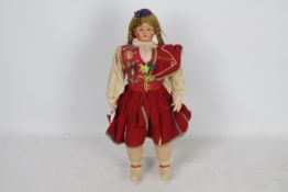 Unknown Maker - A traditional Portuguese costume doll, with composition head, weighted blue eyes,