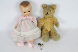 Unknown Maker - A doll and a vintage teddy.