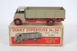 Dinky - A boxed Guy 4 Ton Lorry # 511 in fawn and red.