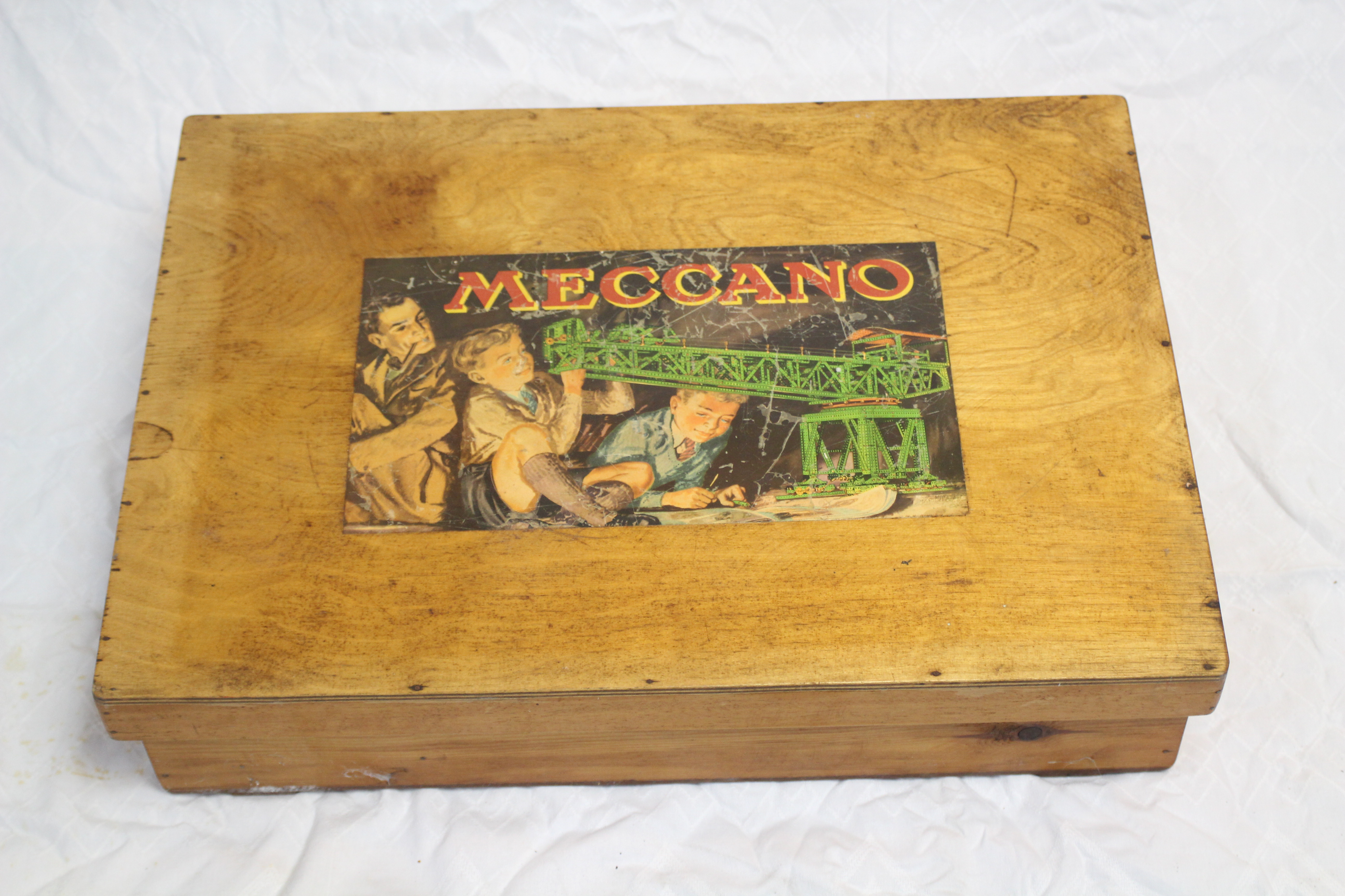 Meccano - A wooden lift off lid box with Meccano image on lid, featuring handles to both ends,