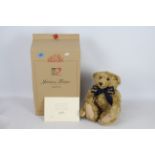 Steiff Teddy Bear - A boxed Steiff Blonde Curly Mohair bear with friendship bracelet 'Centenary