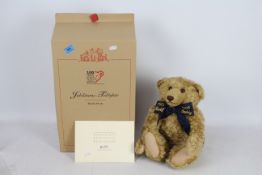 Steiff Teddy Bear - A boxed Steiff Blonde Curly Mohair bear with friendship bracelet 'Centenary