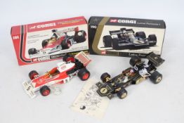 Corgi - 2 x 1:18 scale cars, a Lotus JPS F1 # 190 and a McLaren Texaco-Marlboro M23 F1 # 191.