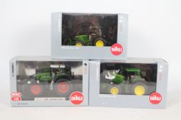 Siku - Three boxed 1:32 scale diecast model tractors from Siku.