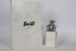 Steiff - A boxed miniature alpaca 'Annual Gift 2010' bear - The grey bear has plastic eyes,