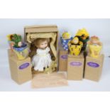 Anne Geddes Collector's dolls - A 38 cm doll in plush suit and cotton apron.