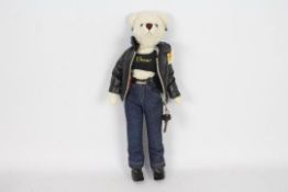 Motor Teddy Bear - A teddy bear dressed in a black leather jacket with blue jeans and black boots.