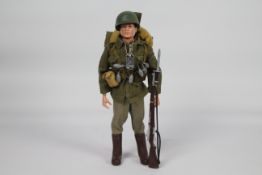 Palitoy, Action Man - A Palitoy dark brown painted head Action Man figure in Combat Soldier outfit.