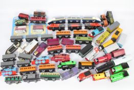 Tomy - Thomas & Friends. An excess of 40 plastic model trains (battery powered) and carriages.