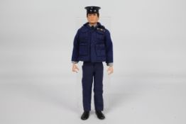 Palitoy, Action Man - A Palitoy Action Man dark brown flock haired figure in RAF Officer outfit.