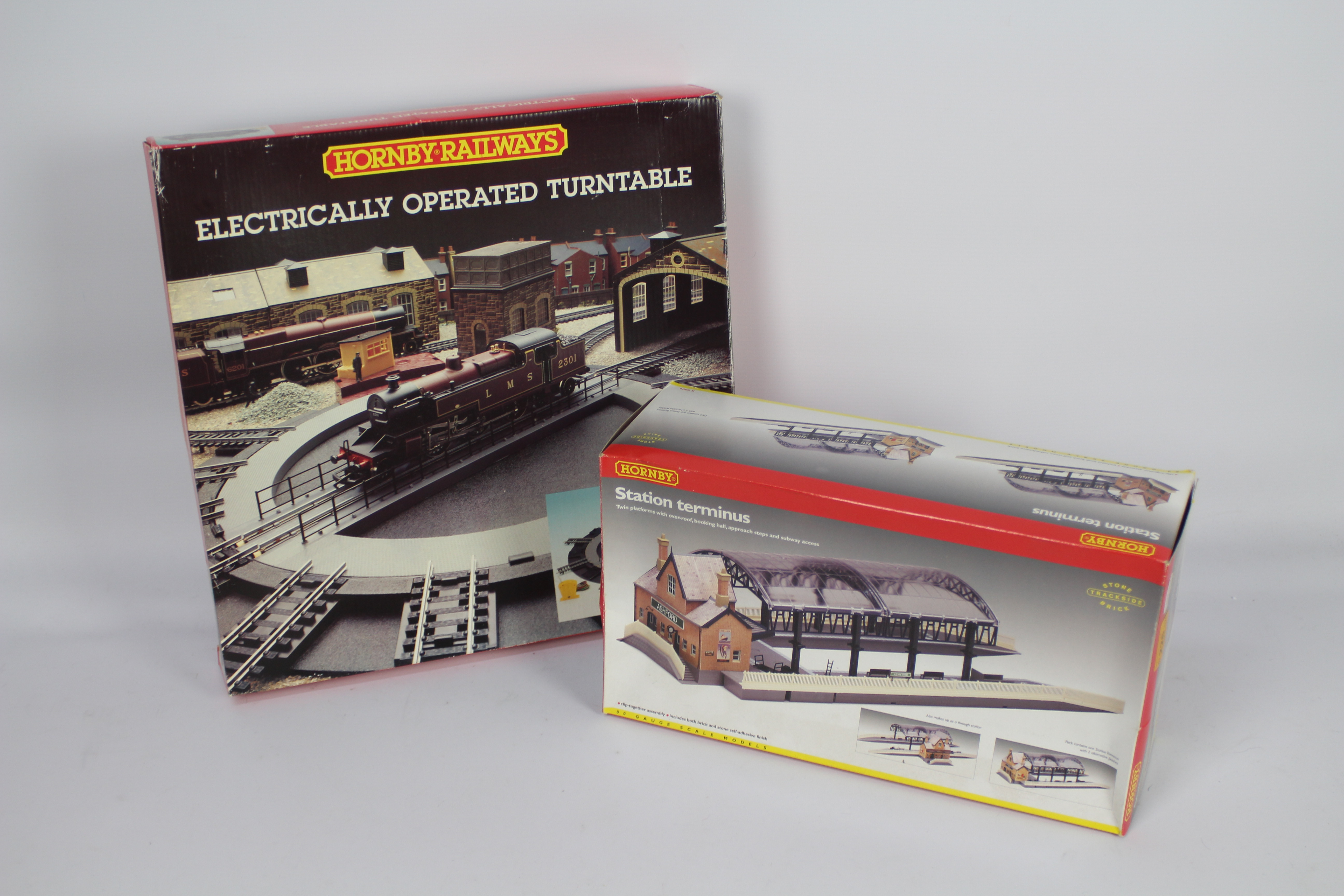 Hornby - A boxed OO gauge Station Terminus # R8009 and a boxed electrically operated Turntable #