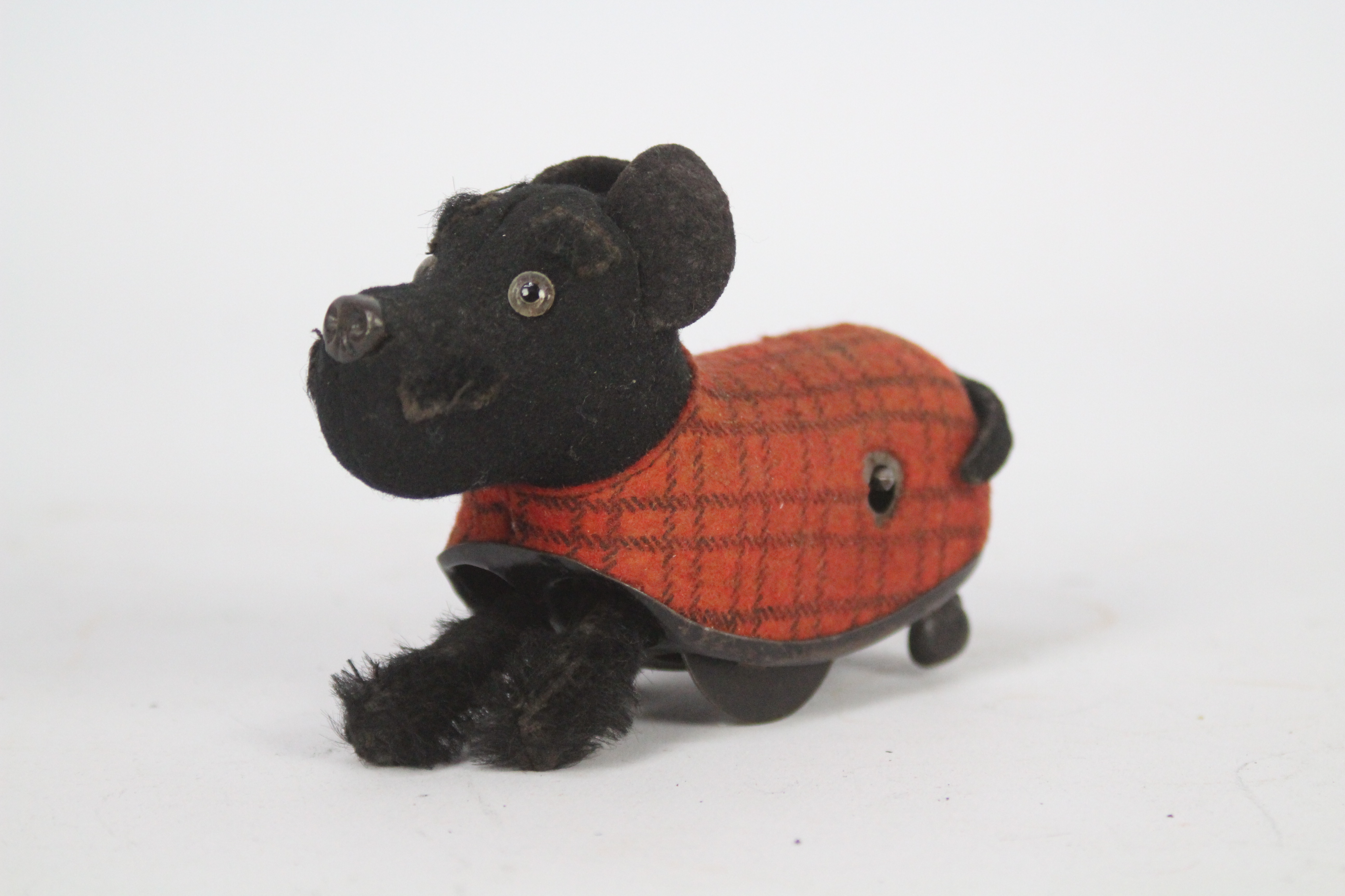 Schuco - A vintage Schuco clockwork dog with plaid coat.