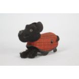 Schuco - A vintage Schuco clockwork dog with plaid coat.