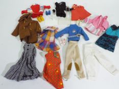 Sindy - A collection of 12 x items of vintage Sindy clothing and 4 pairs of shoes including a two