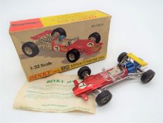 Dinky Toys - a Lotus F1 Racing Car # 225, red body, blue engine, white base, with driver figure,