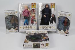 Wizarding World - A collection of 4 x boxed Harry Potter figures and a boxed Harry Potter Puzzle -
