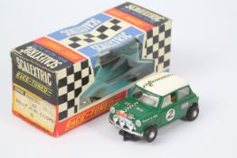 Scalextric - A boxed Scalextric #C7 'Race Tuned' Rally Mini Cooper slot car.