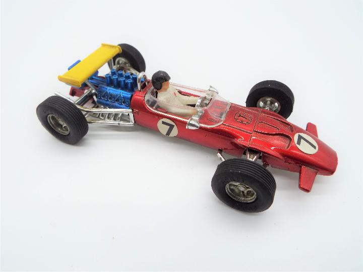 Dinky Toys - a Lotus F1 Racing Car # 225, red body, blue engine, white base, with driver figure, - Image 2 of 2