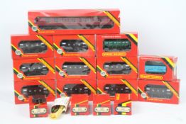 Hornby - A boxed collection of OO gauge rolling stock and track parts.