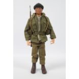 Palitoy, Action Man - A Palitoy dark brown painted hard head Action Man in Combat Soldier outfit,