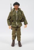 Palitoy, Action Man - A Palitoy dark brown painted hard head Action Man in Combat Soldier outfit,