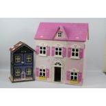 Two unmarked dolls houses. Lot includes a pink and white house measuring approx.